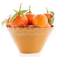 Tangerines on ceramic yellow bowl