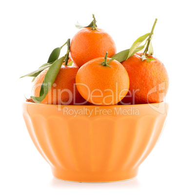 Tangerines on ceramic orange bowl