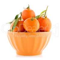 Tangerines on ceramic orange bowl
