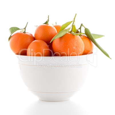 Tangerines on ceramic white bowl