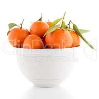 Tangerines on ceramic white bowl