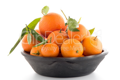 Tangerines on clay bowl