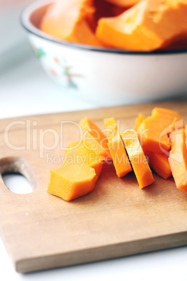 pieces of fresh raw pumpkin on a cutting board