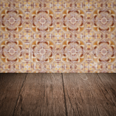 Wood table top and blur vintage ceramic tile pattern wall