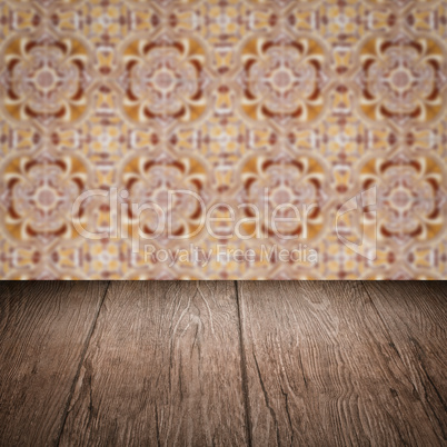 Wood table top and blur vintage ceramic tile pattern wall