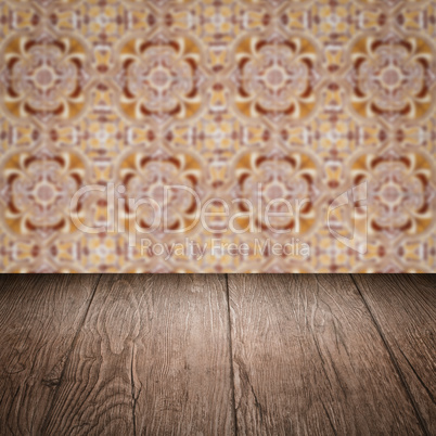 Wood table top and blur vintage ceramic tile pattern wall Wood table top and blur vintage ceramic tile pattern wall