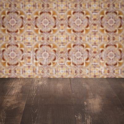 Wood table top and blur vintage ceramic tile pattern wall