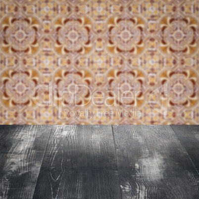 Wood table top and blur vintage ceramic tile pattern wall