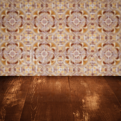 Wood table top and blur vintage ceramic tile pattern wall