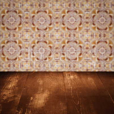 Wood table top and blur vintage ceramic tile pattern wall