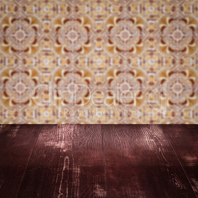 Wood table top and blur vintage ceramic tile pattern wall