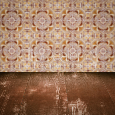 Wood table top and blur vintage ceramic tile pattern wall