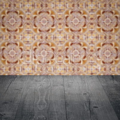 Wood table top and blur vintage ceramic tile pattern wall