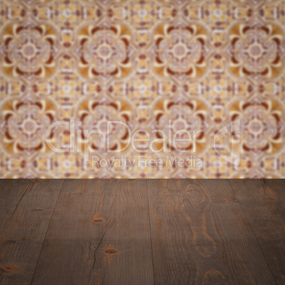 Wood table top and blur vintage ceramic tile pattern wall