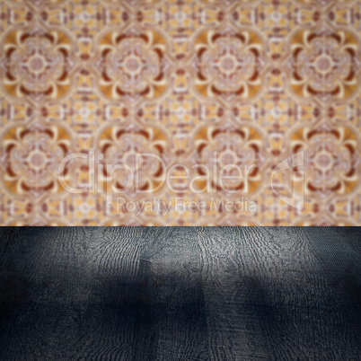 Wood table top and blur vintage ceramic tile pattern wall Wood table top and blur vintage ceramic tile pattern wall