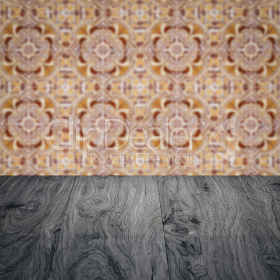 Wood table top and blur vintage ceramic tile pattern wall