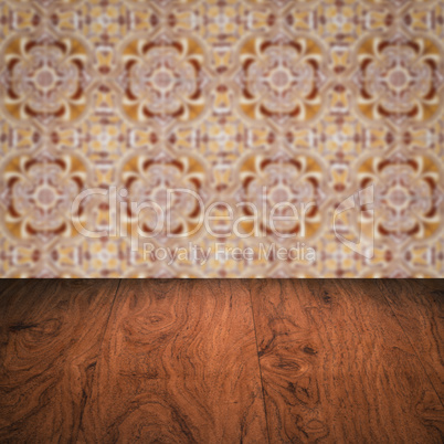 Wood table top and blur vintage ceramic tile pattern wall