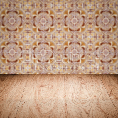 Wood table top and blur vintage ceramic tile pattern wall Wood table top and blur vintage ceramic tile pattern wall