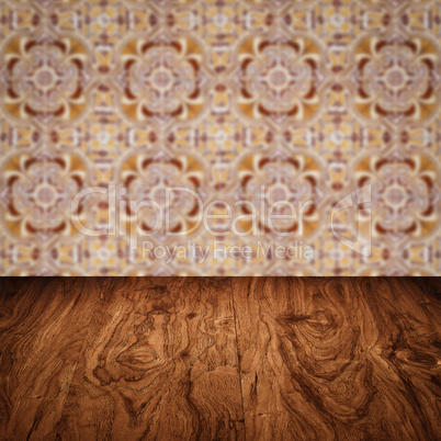 Wood table top and blur vintage ceramic tile pattern wall