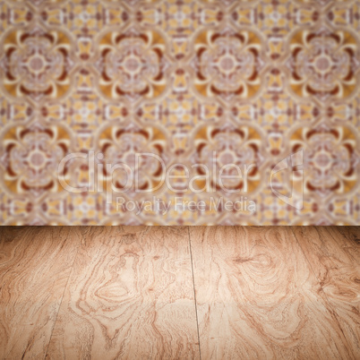 Wood table top and blur vintage ceramic tile pattern wall Wood table top and blur vintage ceramic tile pattern wall
