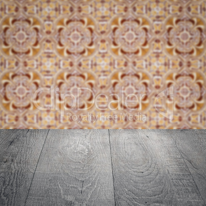 Wood table top and blur vintage ceramic tile pattern wall Wood table top and blur vintage ceramic tile pattern wall