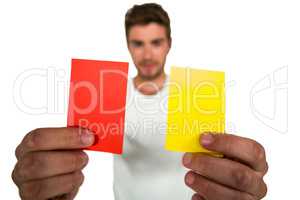 Handsome supporter showing red and yellow cards