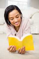 Smiling brunette reading a book