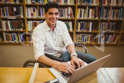 Student in wheelchair typing on his laptop