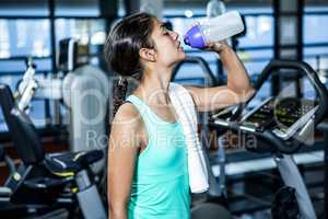 Fit woman drinking water