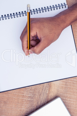 Businessman writing on book