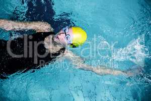 Fit female swimmer doing the back stroke