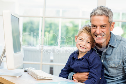 Father and son using the computer