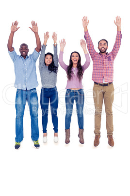 Friends jumping with arms raised