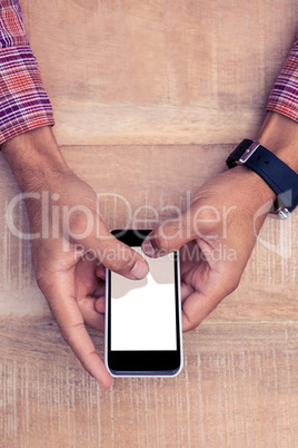Person using smart phone on desk