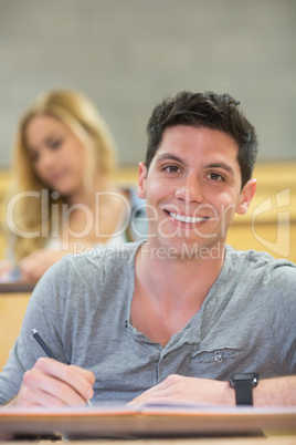 Smiling male student during class