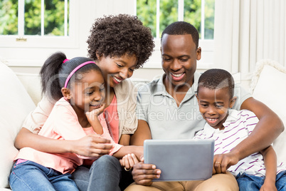 Happy family using tablet on the sofa