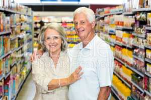 Happy senior couple at the supermarket