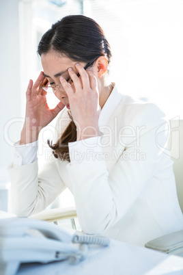 Stressed businesswoman working at her desk