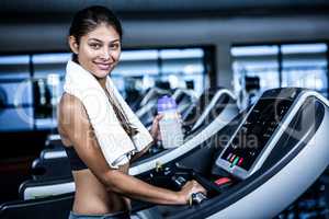 Smiling fit woman on treadmill