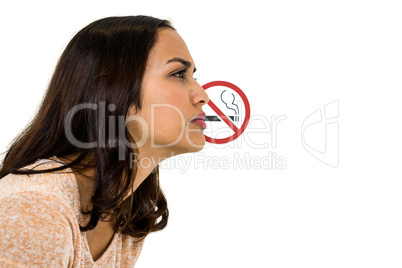 Serious woman looking away with no smoking sign
