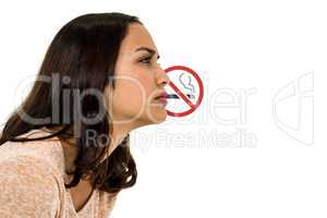 Serious woman looking away with no smoking sign