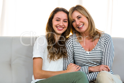 Mother and daughter smiling