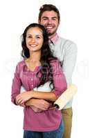 Portrait of stylish couple holding paint roller