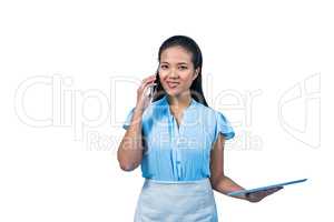 Smiling businesswoman with tablet phoning