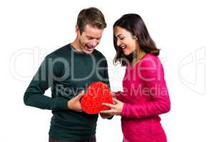 Happy young couple with heart shape gift