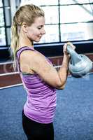 Portrait of woman holding kettlebell