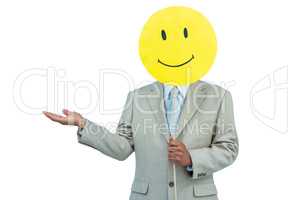 Businessman holding happy smiley face balloon