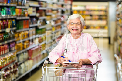 Smiling senior woman with grocery list