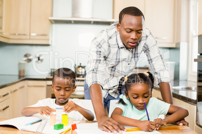 Father helping children for homework