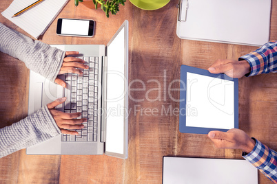 Overhead view of hands working at desk